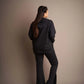 Bold and beautiful: A woman exuding confidence in a stunning black jacket, a timeless symbol of modern sophistication.