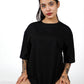 Step into contemporary charm with black apple-cut T-shirt, a fashionable choice for women seeking modern style