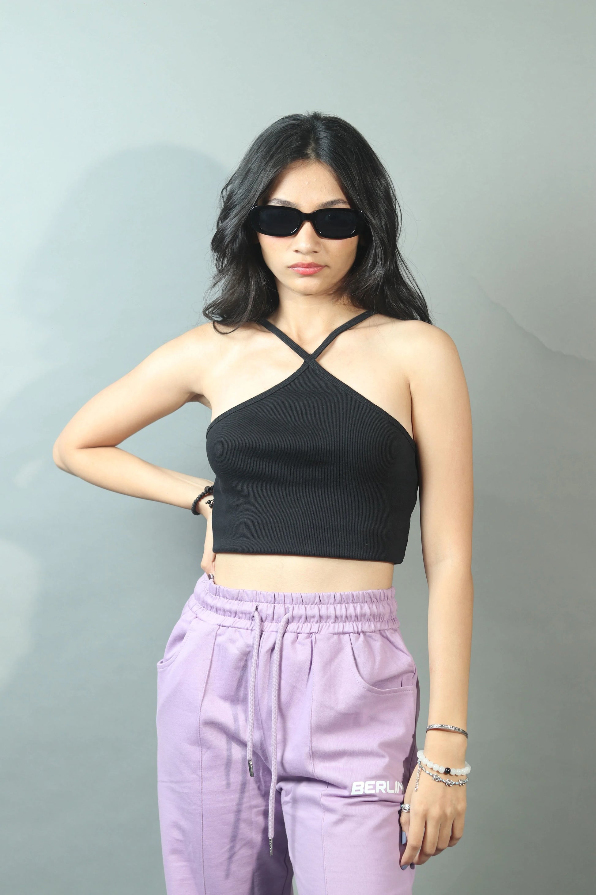 Infuse streetwear vibes into your look with this women's black crop tank top, a stylish and urban addition to your wardrobe.