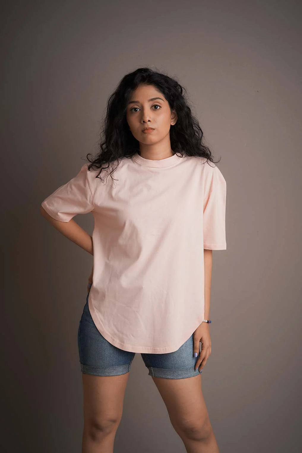 Step into brightness and trendiness with this pink-colored apple-cut T-shirt, perfect for a lively and stylish look.